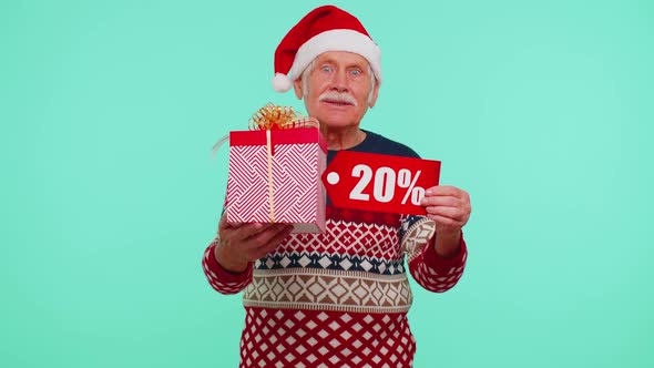 Grandfather in Christmas Sweater Showing Gift Box and 20 Percent Discount Inscriptions Banner Text