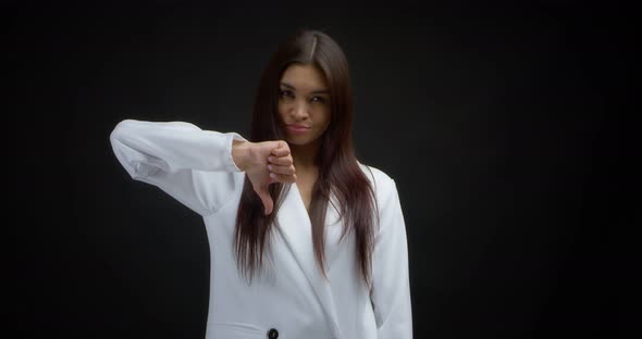 Disgruntled Woman Shows a Sign of Disapproval Lowers Her Thumb