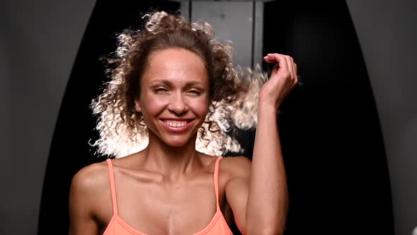 Portrait of a Beautiful Caucasian Woman with Curly Hair Flying in the Wind