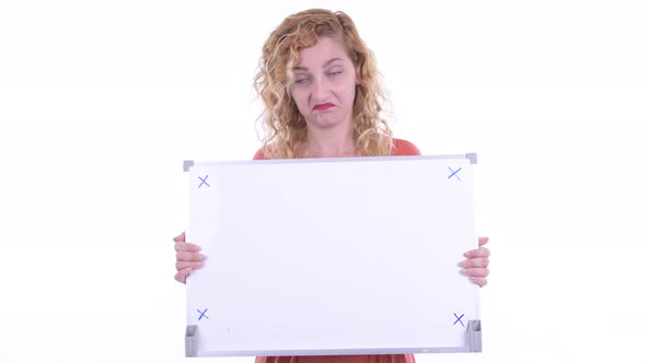 Stressed Blonde Businesswoman Holding White Board