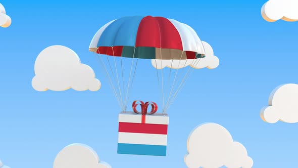 Carton with Flag of Luxembourg Falls with a Parachute