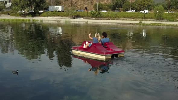 Cute Couple Enjoying A Boat Ride In The Park