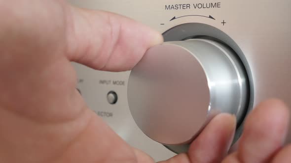 Setting volume up on silver modern audio amplifier jog dial 4K 2160p UltraHD footage - Higher volume