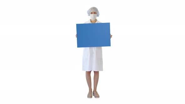 Young Woman Doctor in a Mask Holding an Empty Bill Board on White Background
