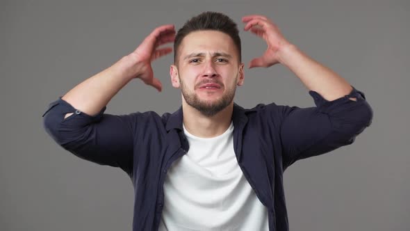 Portrait of Irritated Young Man in Casual Clothing Yelling Question Why and Gesturing in Puzzlement