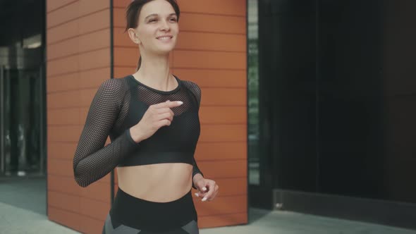 Sports Girl Jogging in the City