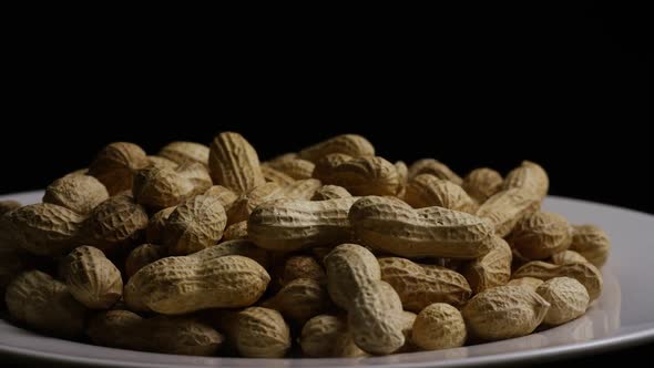 Cinematic, rotating shot of peanuts on a white surface - PEANUTS 026