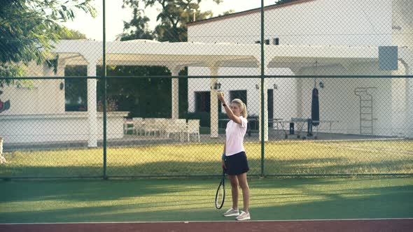 Female Tennis Player Preparing To Set Ready To Serve Ball. Girl With Rocket Playing On Tennis Court.