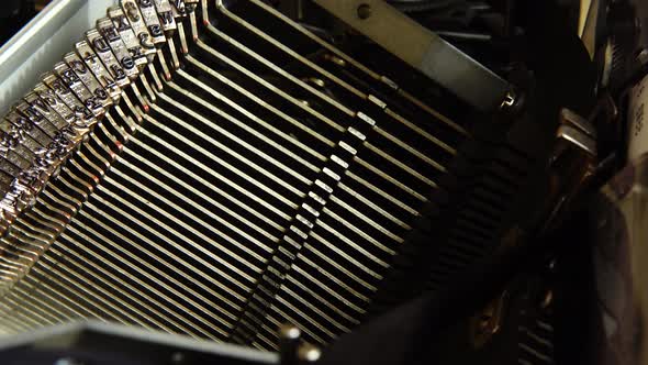 Mechanism of a retro typewriter. Old typewriter hammers. Close up.