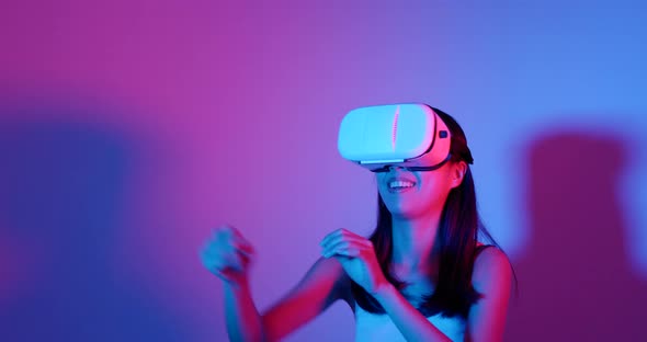 Woman looking though VR device with red and blue light 