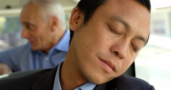 Business commuter sleeping while travelling in bus 4k