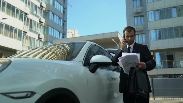 Businessman Talking on Phone Near Car, Solving Financial Issues of Company