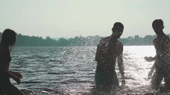 Young Guys and Girls Having Fun in the Water