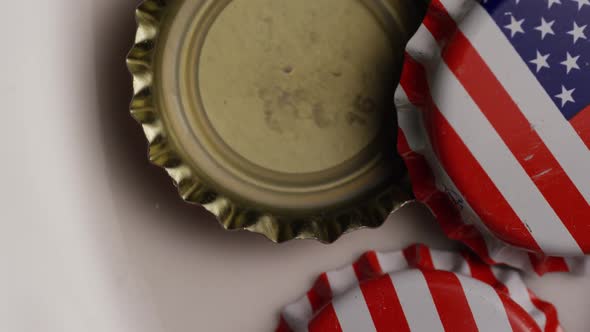 Rotating shot of bottle caps with the American flag printed on them