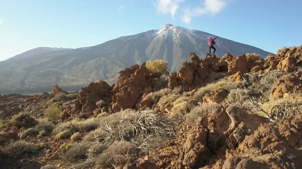 Young Woman Arms Outstretched Observes a Huge Crater of Teide Volcano, Tenerife, Canary Islands