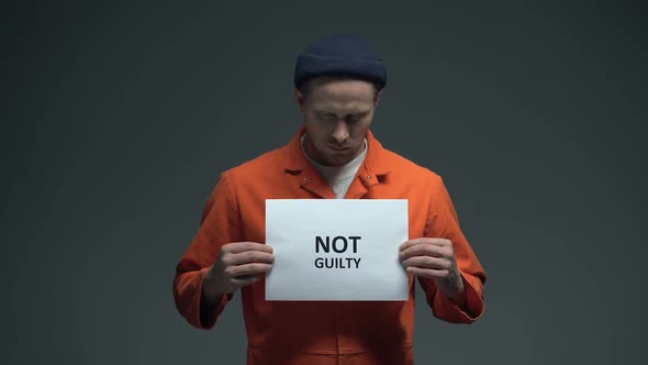Caucasian Prisoner Holding Not Guilty Sign, Asking for Justice, Human Rights
