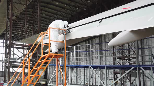 Repair of An Aircraft Wing. Painting the Wing of The Aircraft in White