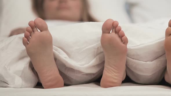 Feet of Couple in Comfortable Bed Honeymoon Sleeping Time Romantic Rest