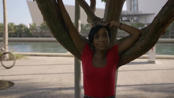 Woman Posing By A Tree In The Shade