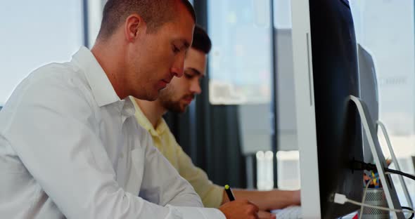 Business executives working over computer