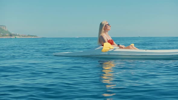 Paddling Canoe Adventure. Tourist Woman Spending Day Kayaking On Sea. Journey On Kayaking Summer.