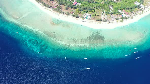 Colorful seascape of blue turquoise sea water around white sandy beach of tropical island, boats sai