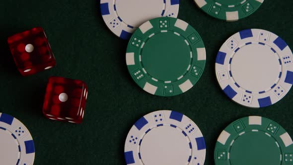 Rotating shot of poker cards and poker chips on a green felt surface - POKER 040