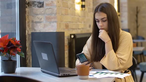 Confident Millennial Businesswoman Working Online in Cafe