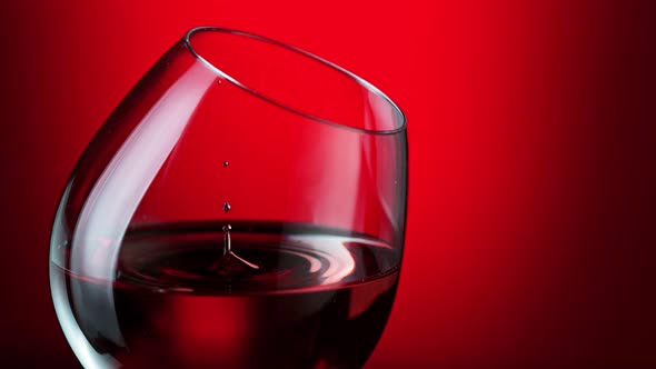 Super Slow Motion Shot of Wine Drop Falling Into Red Wine in Glass at 1000Fps