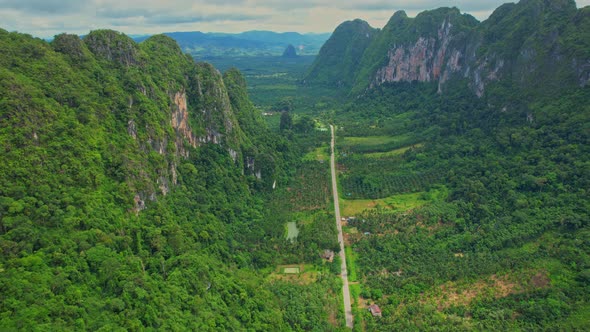 An aerial view from a drone flying over a beautiful mountain view road