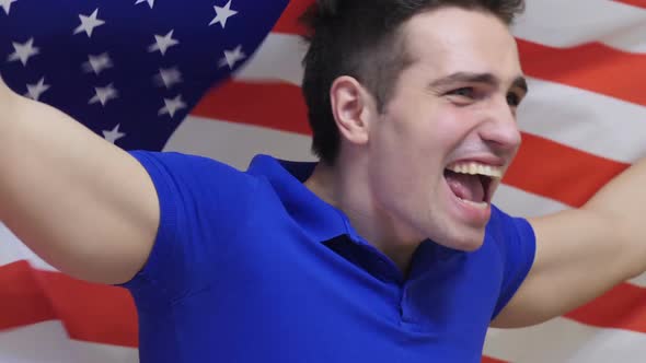 American Young Man Celebrating While Holding the Flag of America in Slow Motion
