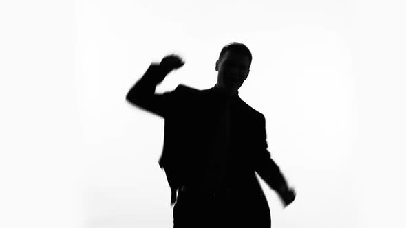 Businessman Silhouette Raises Fist Up, Celebrates Success, Proud of Achievement