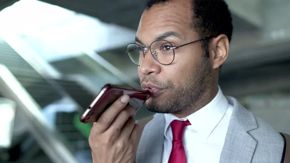 Serious Businessman Talking By Cell Phone