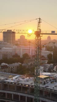 Construction Crane in the City at Sunrise