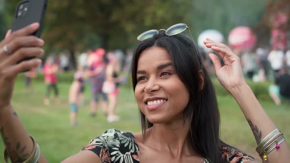 Woman meet friends and making selfie at music festival. Shot with RED helium camera in 8K.