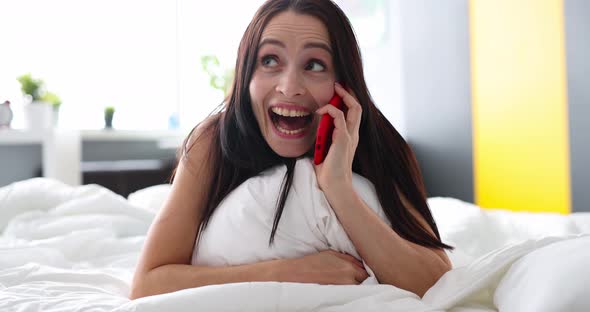 Smiling Happy Woman Talking on Phone While Lying in Bed Closeup