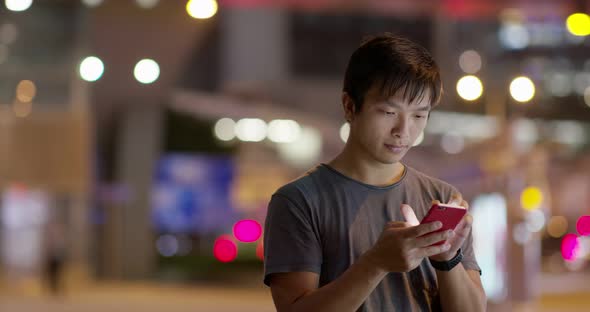 Man Use of Mobile Phone in The Street at Night