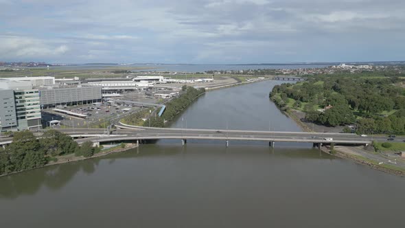 Aerial view of Highway drive with car traffic flowing to Sydney International and Domestic Airport a