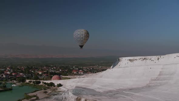 A view on hot air ballon over the white terraces of Pamukkale in Turkey