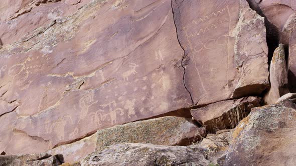 Wide panning view of petroglyphs on cliff in Nine Mile Canyon