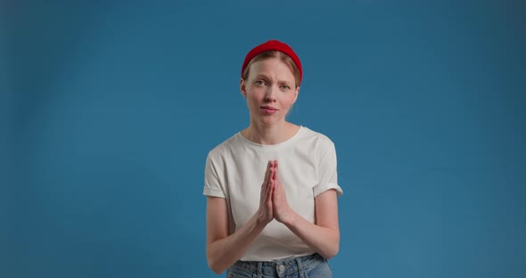 Blonde Woman Holding Hands in Prayer and Pleading to Camera