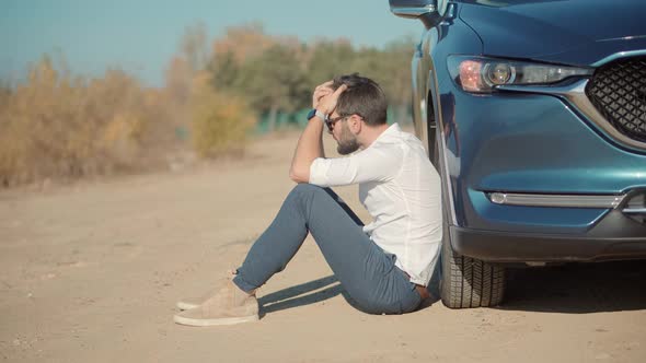 Desperate Businessman Sitting Near Broken Car. Office Burnout Syndrome.  Financial Problem.