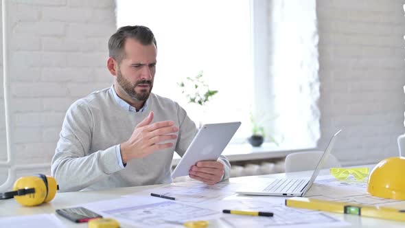Failure Young Architect Having Loss on Tablet in Office