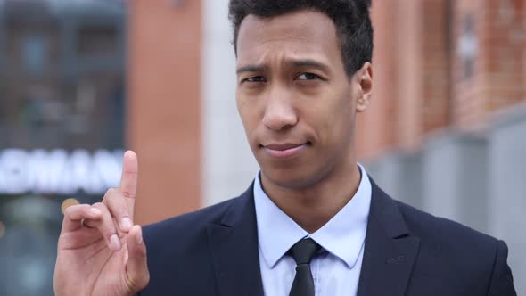 No, African Businessman Rejecting Offer by Waving Finger