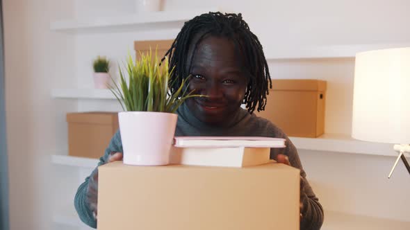 Portrait of Excited Young African American Man Moving in to the New Apartment