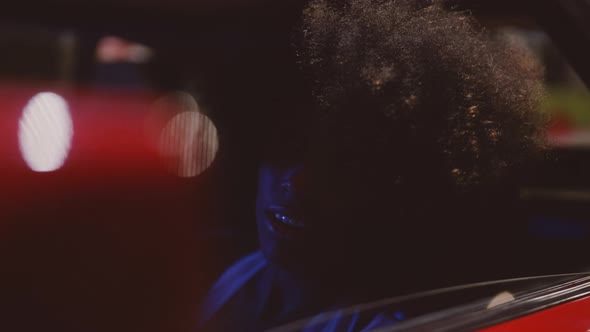 Smiling Woman With Afro Hair In Ferrari 348 TB At Night