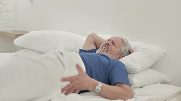 Old Man Waking Up in Bed With Spinal Back Pain