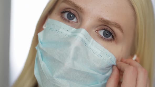 Young Woman Takes Off the Face Mask