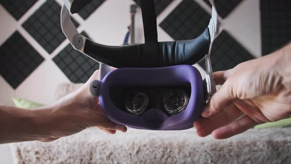 Point of View Young Man Putting on VR Helmet at Home Interior