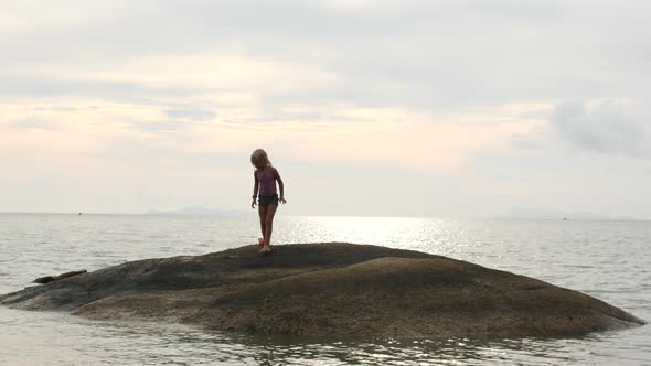 a Child on a Small Island in the Sea